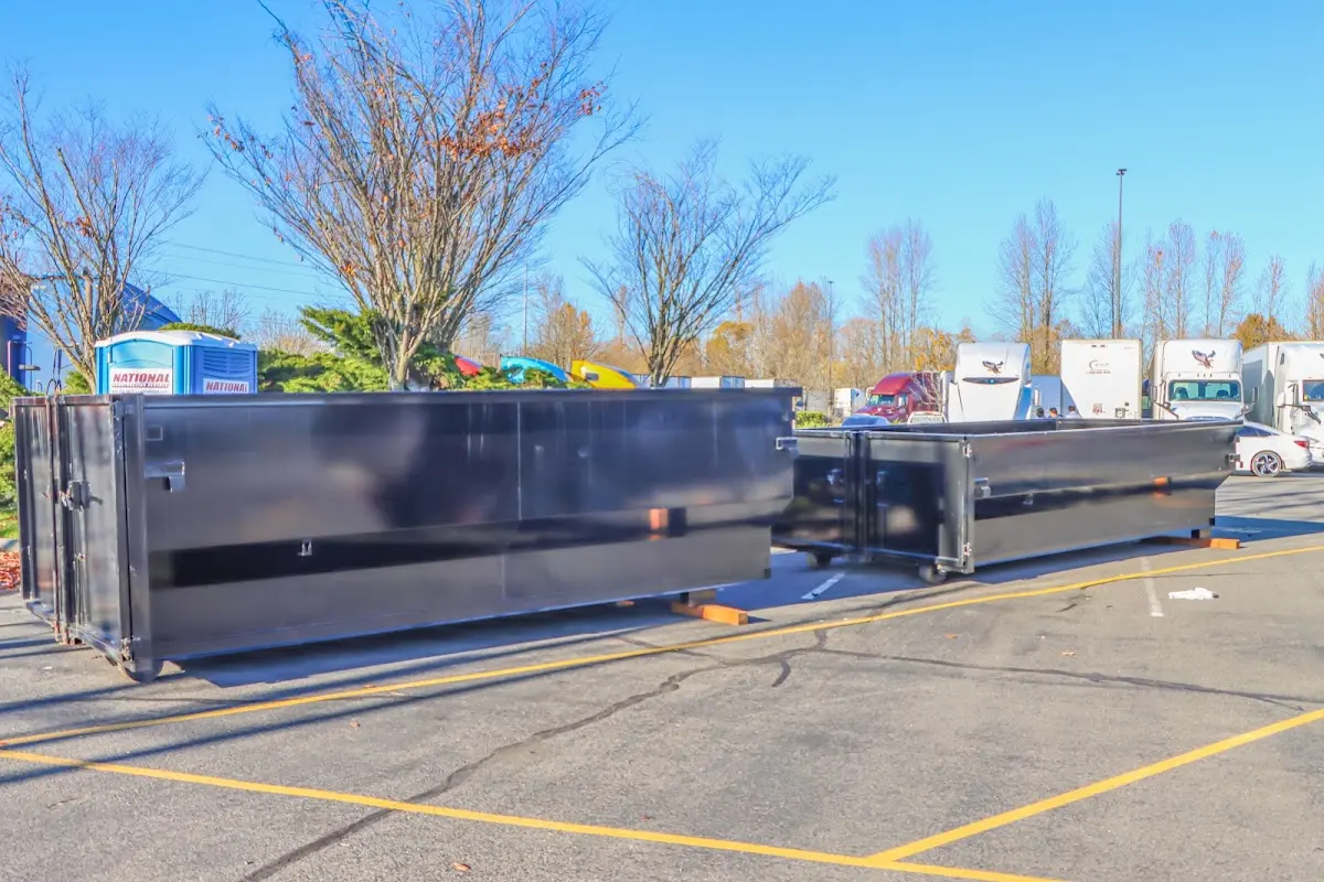 Professional dumpster rental service with roll-off container on residential driveway in Willowick